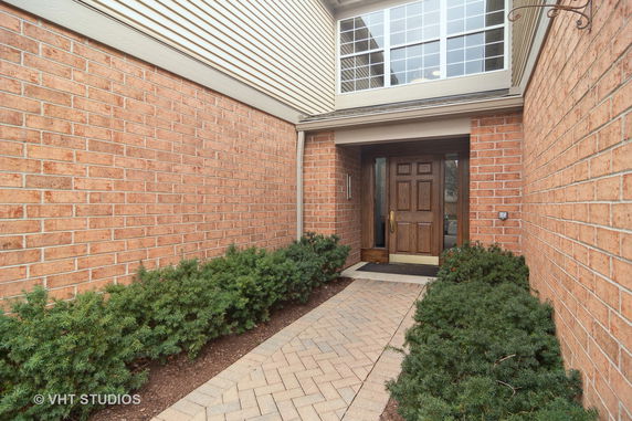 Front view of a house with brick walls and an entrance door.