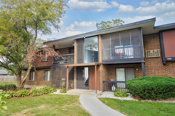 Front view of a two-story apartment building with balconies.