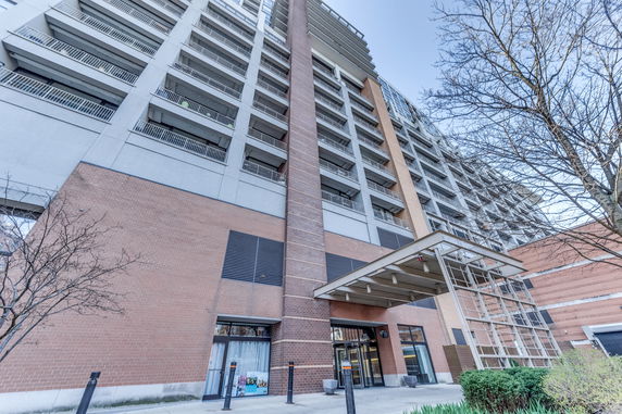 Front view of a multi-story building with balconies and a modern design.
