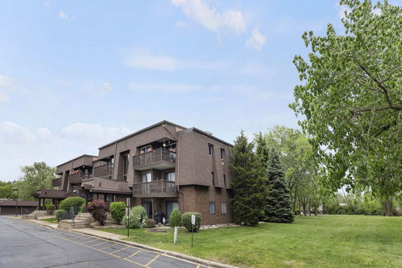 Front view of a multi-story residential building with balconies.