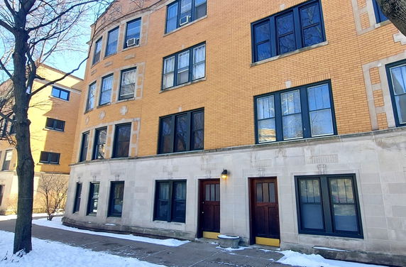 Front view of a multi-story brick apartment building.