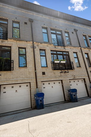 Front view of a multi-story building with garage doors.
