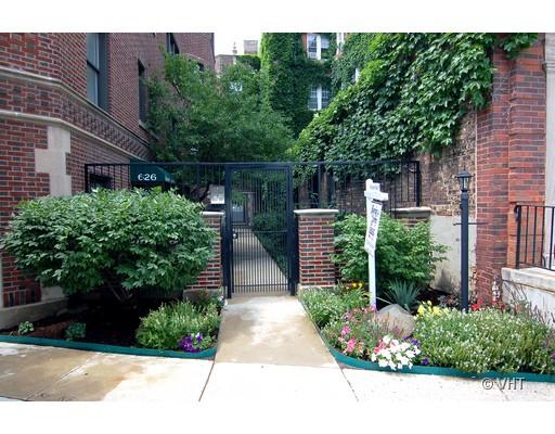 Front view of a building with a gated entrance and brick facade.