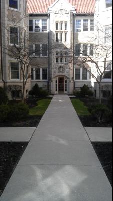 Front view of a multi-story apartment building with a central entrance.