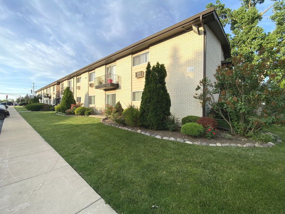 Front view of a two-story apartment building with balconies.