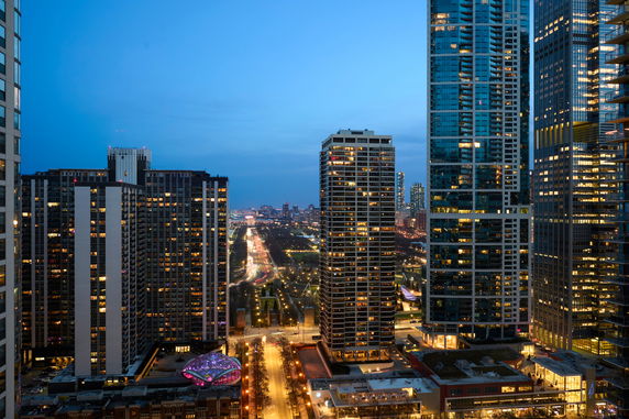 Panoramic view of a cityscape with tall buildings at dusk.