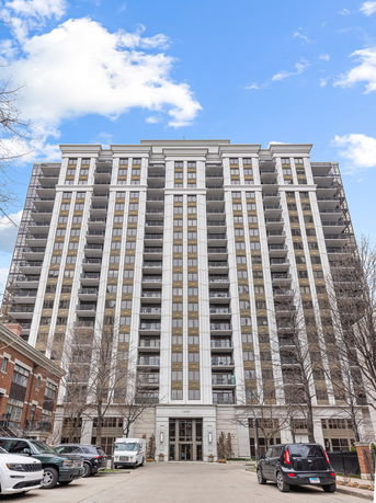 Front view of a multi-story building with balconies.