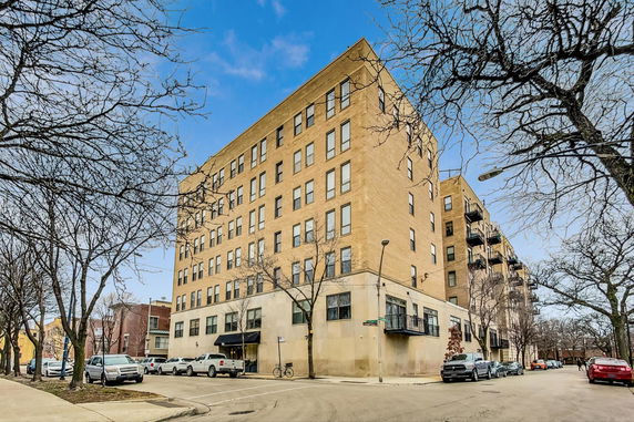 Front view of a multi-story brick apartment building.
