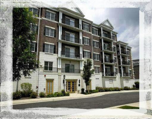 Front view of a multi-story apartment building with balconies.