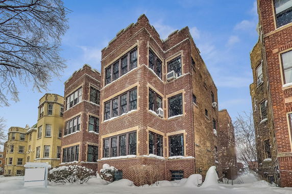 Front view of a multi-story brick building in winter.