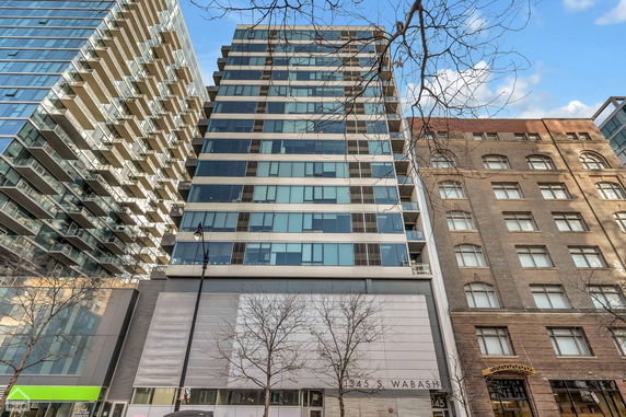 Front view of a high-rise building with multiple balconies and a modern design.