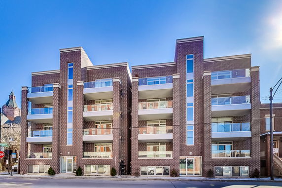 Front view of a multi-story apartment building with balconies.