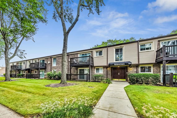 Front view of a two-story apartment building with balconies.