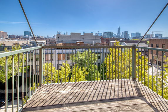 View from a balcony with cityscape in the background.