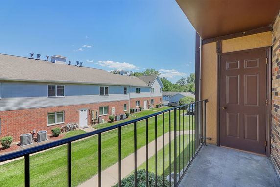 View of surrounding areas from a building with other residential units in the background.
