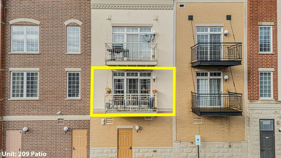 Front view of a multi-story building with balconies.