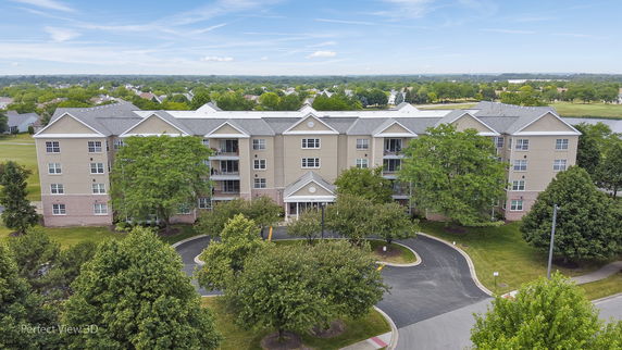 Front view of a multi-story apartment building with multiple balconies.