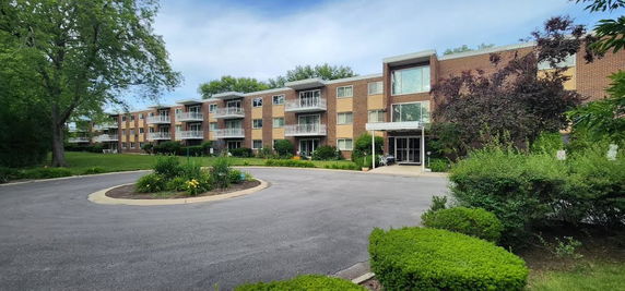 Front view of a multi-story apartment building with balconies.