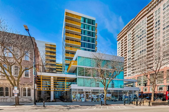 Front view of a multi-story building with modern architecture and glass facade.