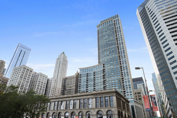 Front view of multiple tall commercial and residential buildings in an urban area.