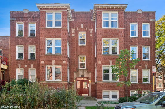 Front view of a red brick multi-story building.