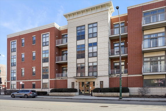 Front view of a multi-story brick apartment building.