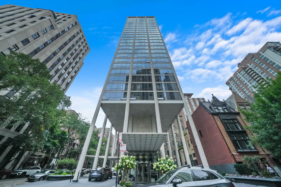 Front view of a modern high-rise building with glass facade.