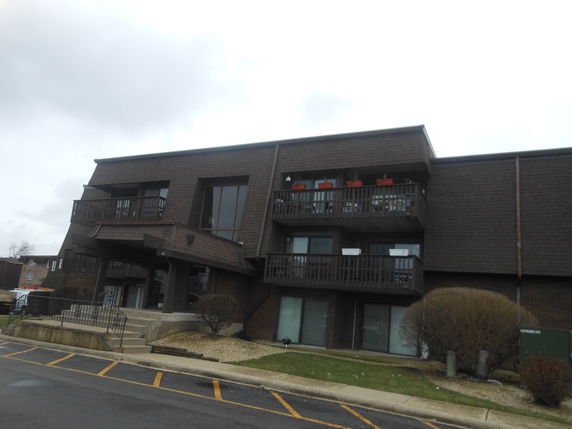 Front view of a multi-story building with balconies.