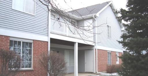 Front view of a two-story building with a mix of brick and siding exterior.