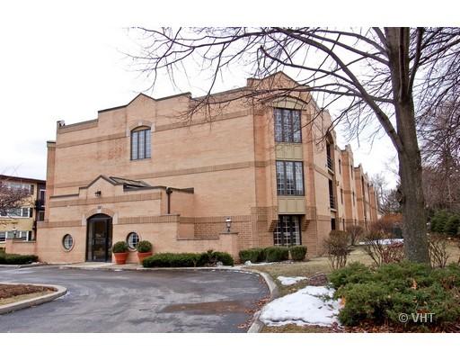 Front view of a multi-story brick building with large windows.
