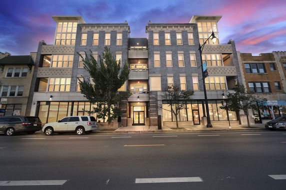 Front view of a multi-story building with large windows and modern design.