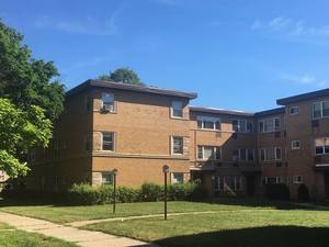 Front view of a multi-story brick apartment building.