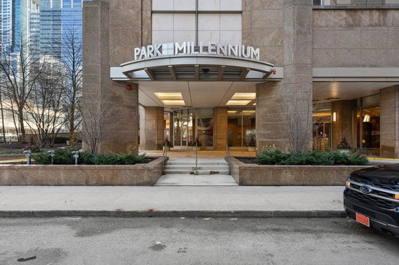 Front view of a modern building entrance with signage reading Park Millennium.
