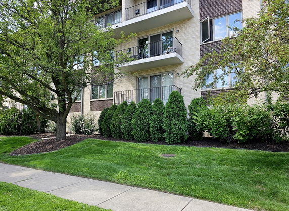 Front view of a multi-story residential building with balconies.