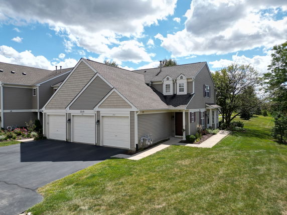 Front view of a two-story house with a three-car garage.