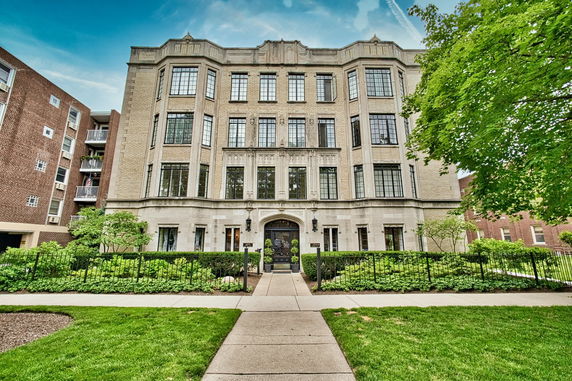 Front view of a multi-story residential building with ornate architecture.