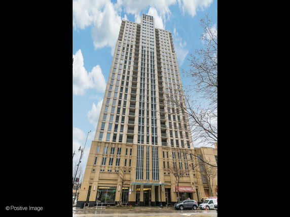 Front view of a tall, modern high-rise building.