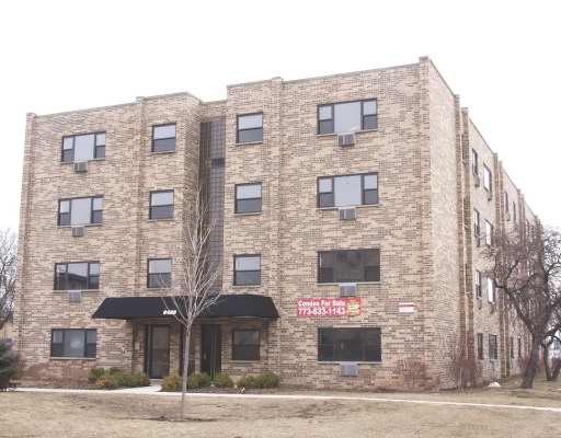 Front view of a multi-story brick apartment building.