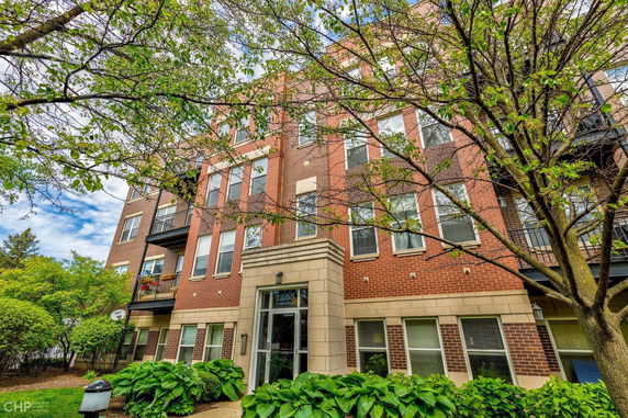Front view of a multi-story brick apartment building.