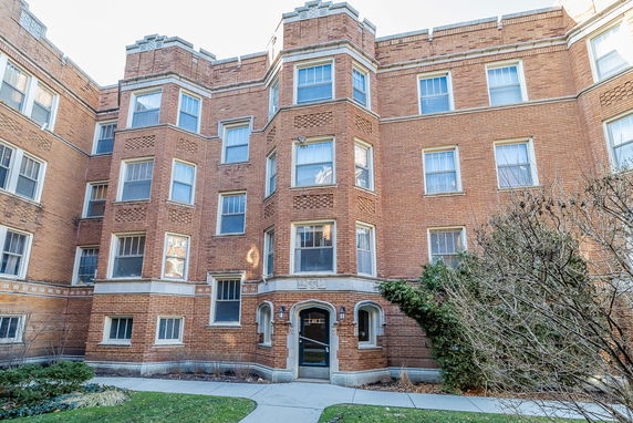 Front view of a multi-story brick apartment building.