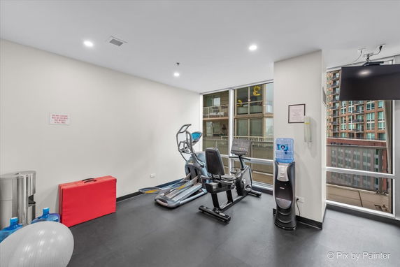 Indoor gym area with exercise equipment and water cooler.