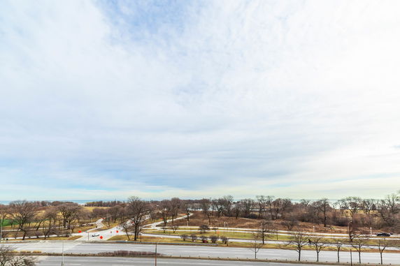Wide-angle view of a landscape with roads and tree-filled open areas.