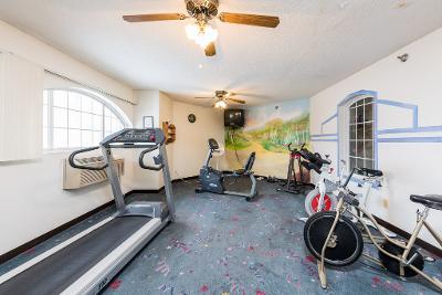 Indoor gym area with exercise equipment such as treadmills and stationary bikes.