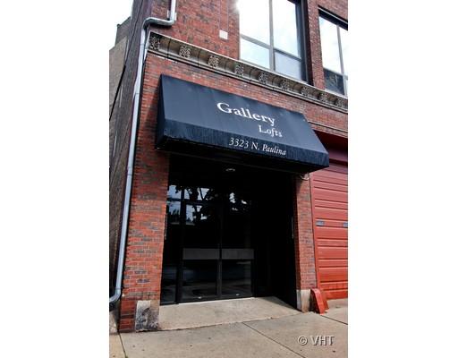 Front view of a brick building with a black awning labeled 'Gallery Lofts.'