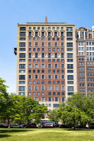 Front view of a multi-story building with a mix of red and beige facade.