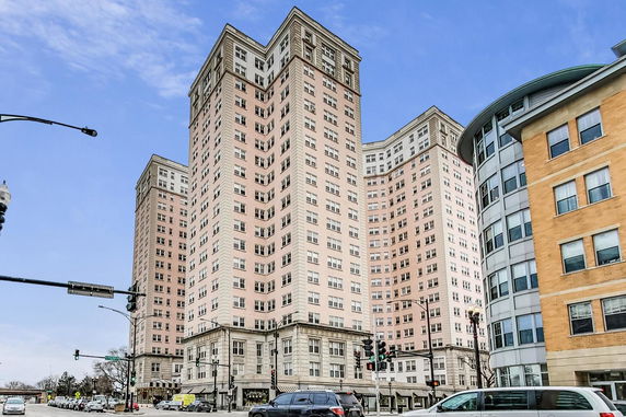 Front view of a high-rise apartment building with multiple wings.