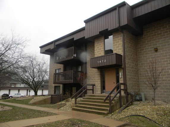 Front view of a multi-story building with balconies.
