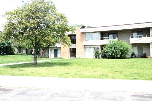Front view of a two-story apartment building with balconies.