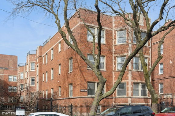 Front view of a multi-story brick apartment building.