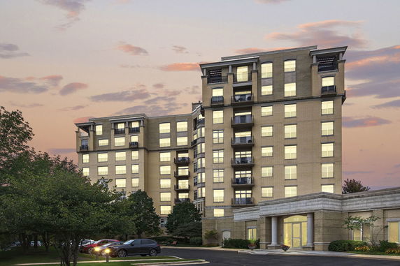 Front view of a multi-story apartment building with balconies.